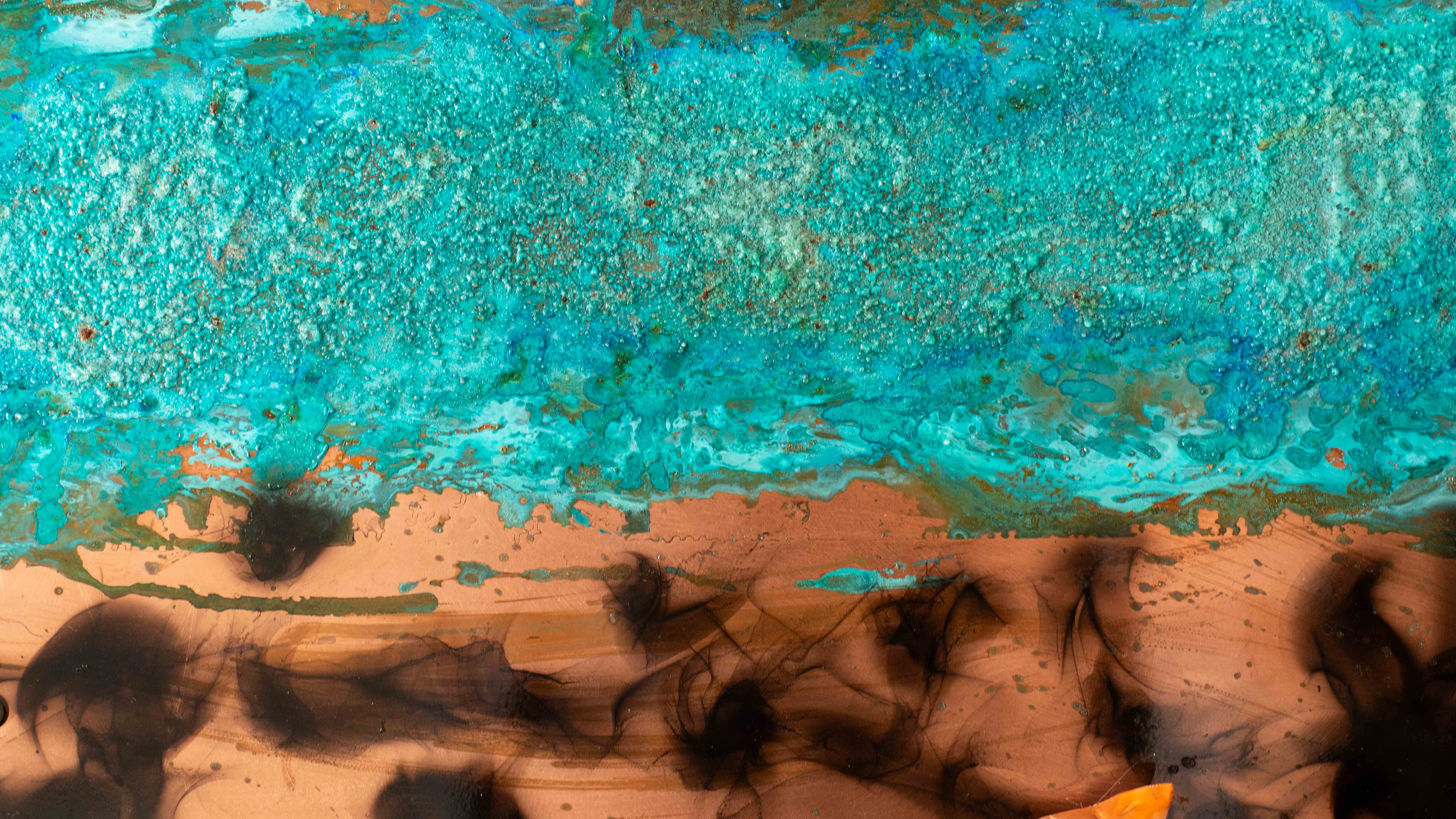 Turquoise patina metal transitioning to warm copper tones